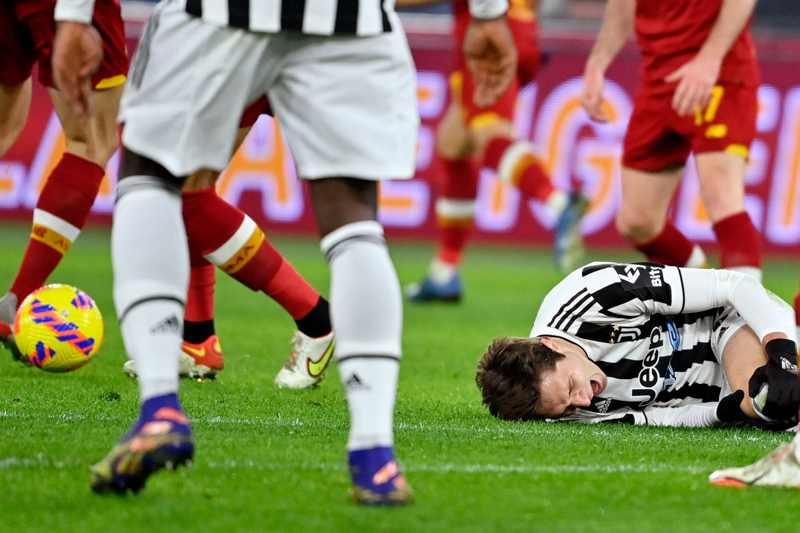 Juventus' Italian forward Federico Chiesa (R) reacts after being tackled by Roma's English defender Chris Smalling (unseen) during the Serie A football match beetween AS Roma and Juventus at the Olympic stadium in Rome on January 9, 2022. (Photo by Alberto PIZZOLI / AFP) (Photo by ALBERTO PIZZOLI/AFP via Getty Images)