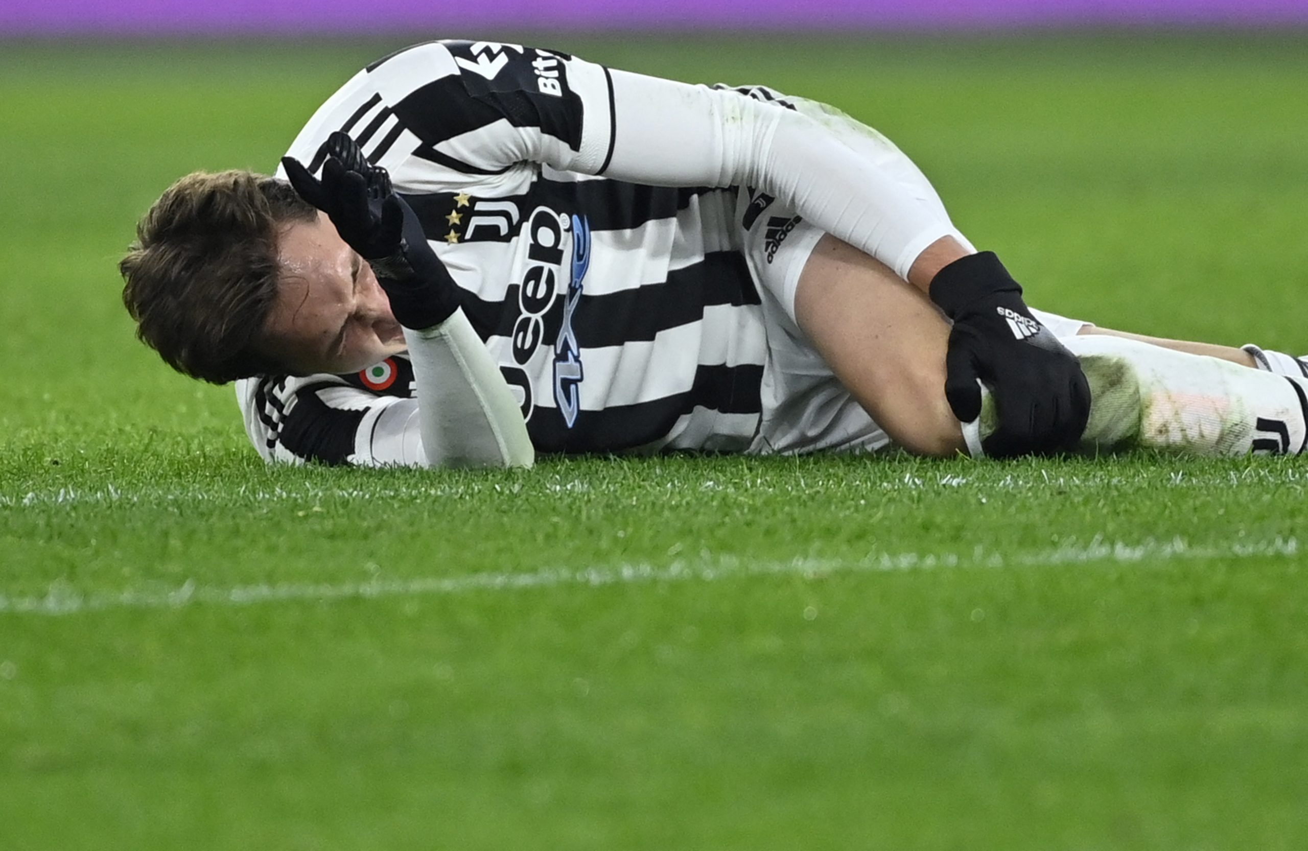 Juventus' Italian forward Federico Chiesa reacts after a tackle during the Serie A football match beetween AS Roma and Juventus at the Olympic stadium in Rome on January 9, 2022. - Federico Chiesa's season is almost certainly over after Juventus announced on January 10 the Italy forward suffered a left knee ligament injury during his team's thrilling win over Roma. (Photo by Alberto PIZZOLI / AFP) (Photo by ALBERTO PIZZOLI/AFP via Getty Images)