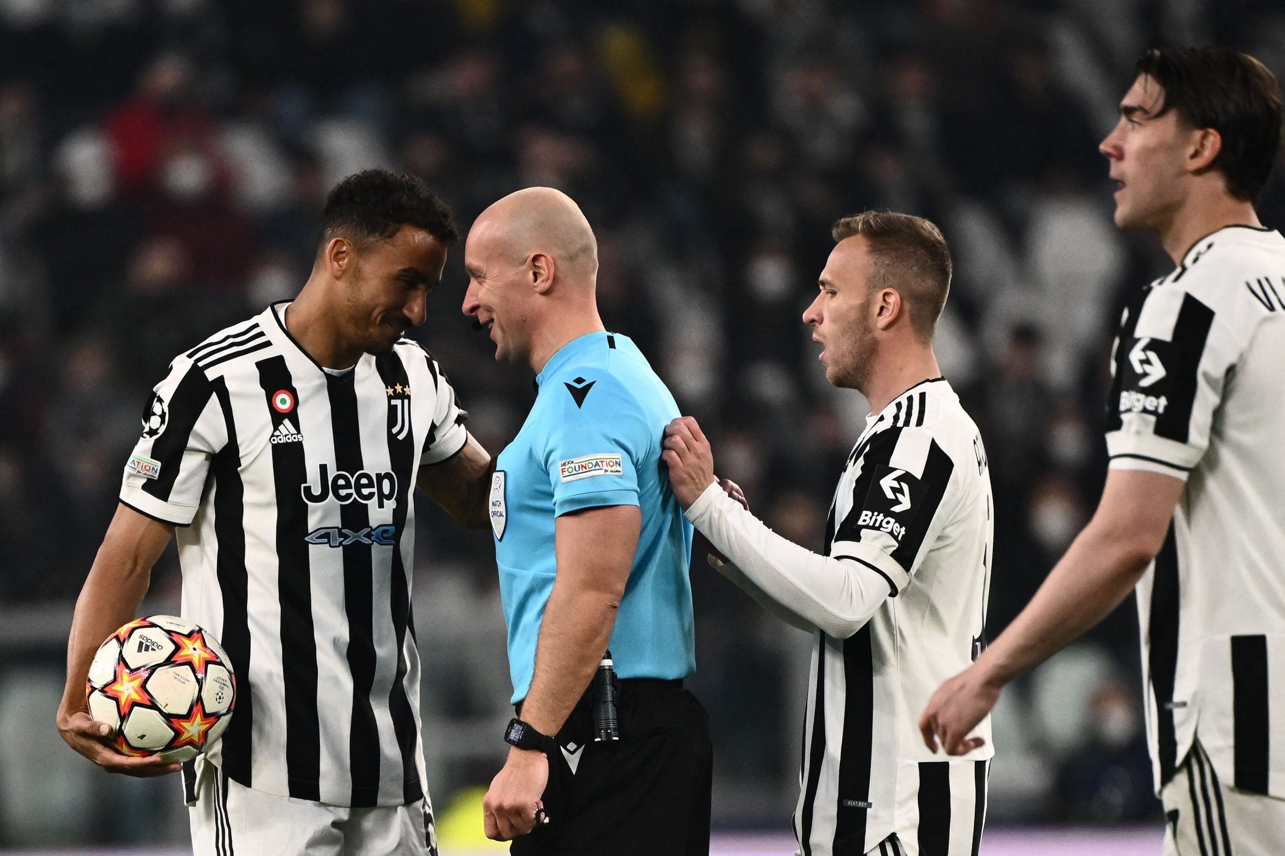 Juventus' Brazilian defender Danilo (L) talks with Polish referee Szymon Marciniak during the UEFA Champions League round of 16 second leg football match between Juventus and Villareal on March 16, 2022 at the Juventus stadium in Turin. (Photo by Marco BERTORELLO / AFP) (Photo by MARCO BERTORELLO/AFP via Getty Images)