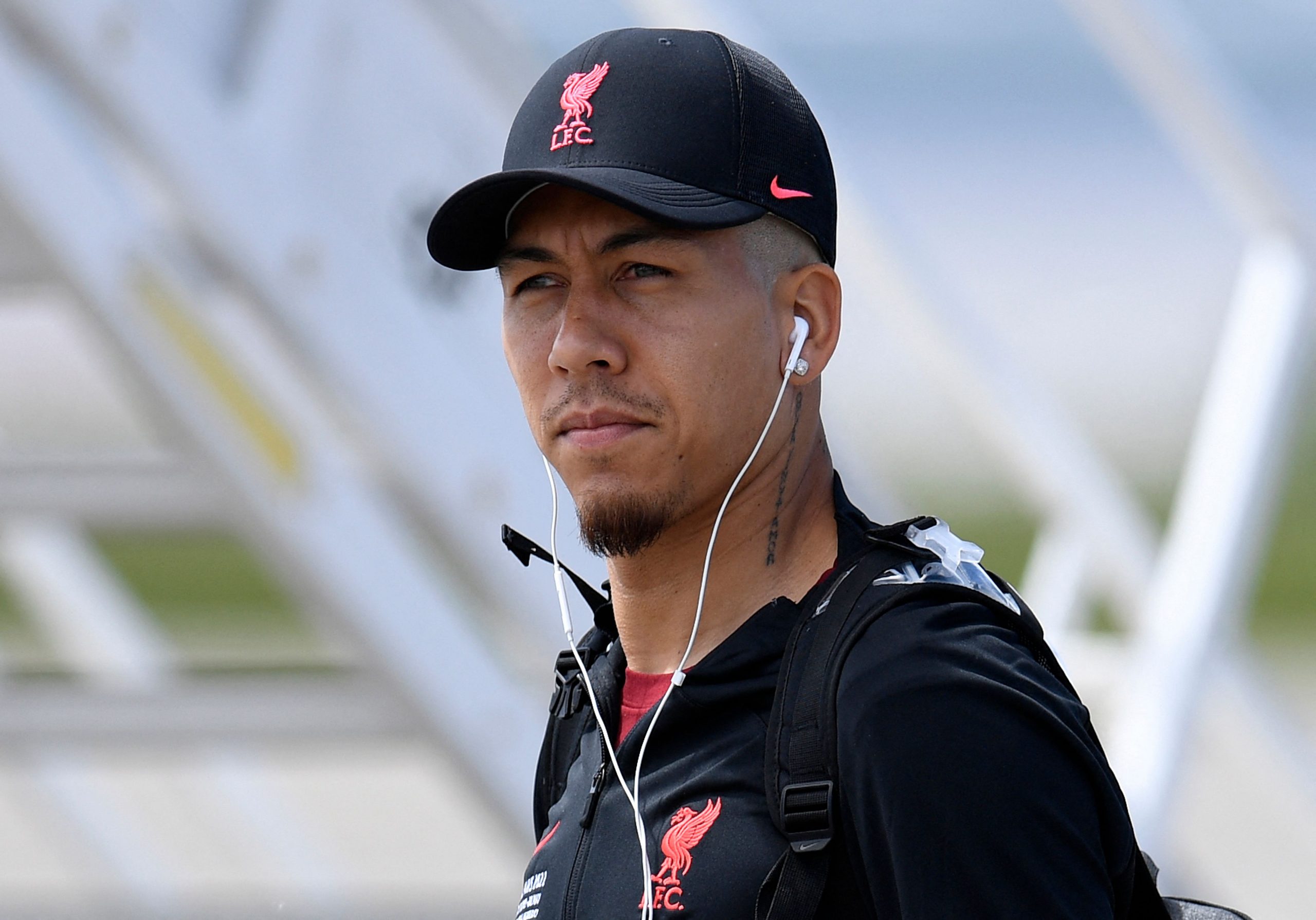 Liverpool's Brazilian striker Roberto Firmino walks to the plane at Liverpool John Lennon Airport on May 27, 2022, before leaving for Paris to compete in the UEFA Champions League final football match against Real Madrid. (Photo by Oli SCARFF / AFP) (Photo by OLI SCARFF/AFP via Getty Images)