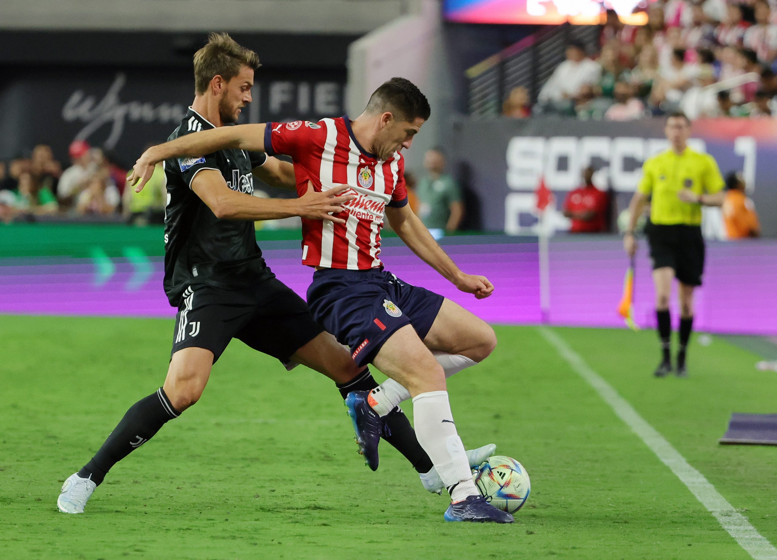 LAS VEGAS, NEVADA - JULY 22: Santiago Ormeño #14 of Chivas holds off Daniele Rugani #24 of Juventus during their preseason friendly match at Allegiant Stadium on July 22, 2022 in Las Vegas, Nevada. Juventus defeated Chivas 2-0. (Photo by Ethan Miller/Getty Images)