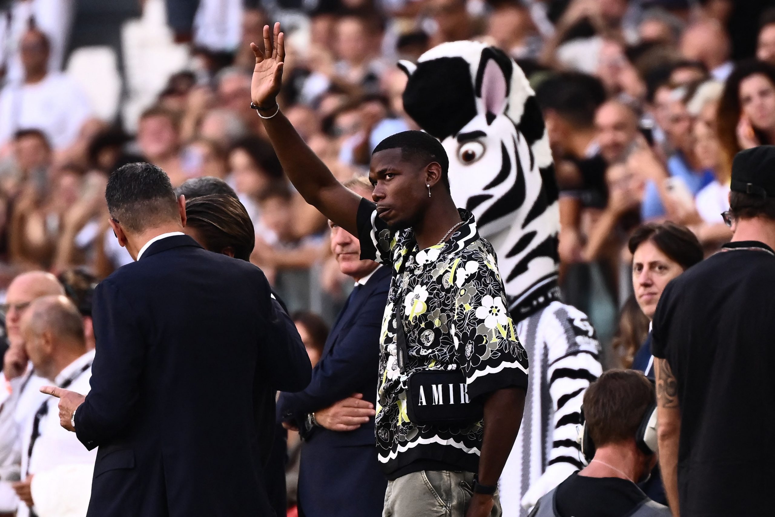 Juventus' French midfielder Paul Pogba, who is currently injured, waves from a tribune prior to the Italian Serie A football match between Juventus and AS Roma on August 27, 2022 at the JUventus stadium in Turin. (Photo by Marco BERTORELLO / AFP) (Photo by MARCO BERTORELLO/AFP via Getty Images)