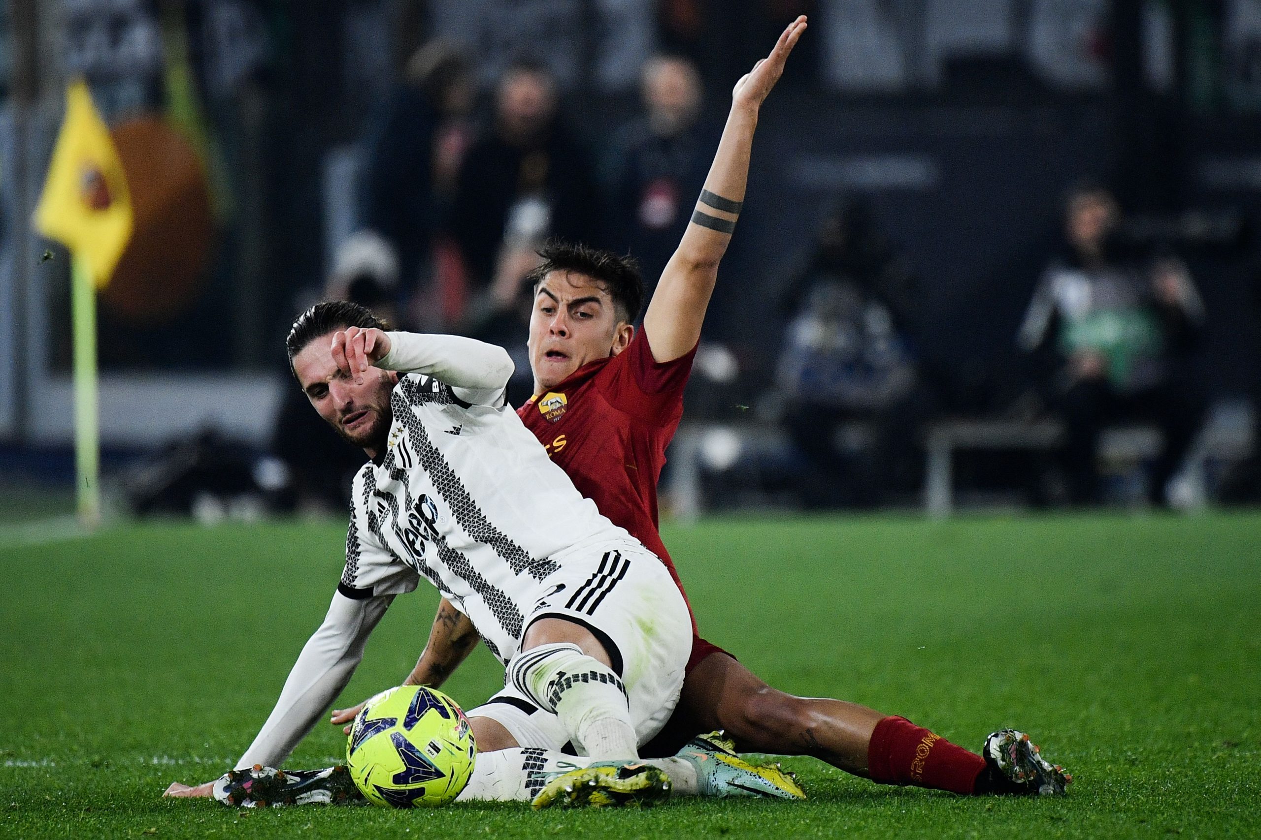 AS Roma's Argentinian forward Paulo Dybala (Rear) tackles Juventus' French midfielder Adrien Rabiot during the Italian Serie A football match between AS Roma and Juventus on March 5, 2023 at the Olympic stadium in Rome. (Photo by Filippo MONTEFORTE / AFP) (Photo by FILIPPO MONTEFORTE/AFP via Getty Images)