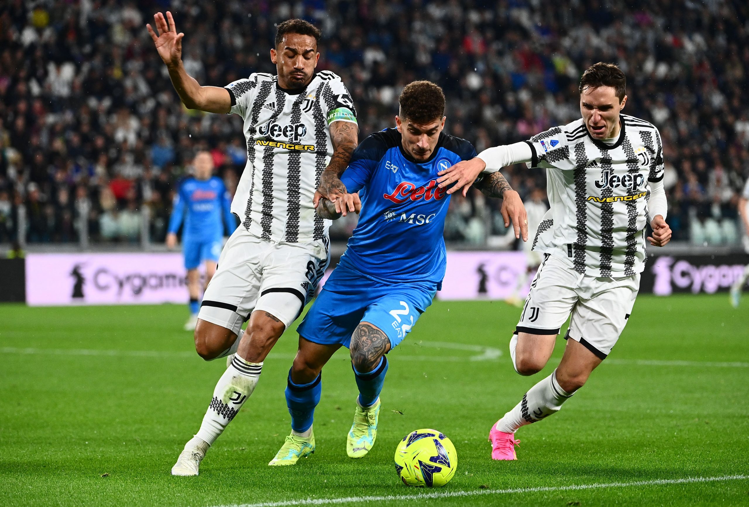 Napoli's Italian defender Giovanni Di Lorenzo (C) fights for the ball with Juventus' Brazilian defender Danilo (L) and Juventus' Italian forward Federico Chiesa during the Italian Serie A football match between Juventus and Napoli on April 23, 2023 at the Juventus stadium in Turin. (Photo by Isabella BONOTTO / AFP) (Photo by ISABELLA BONOTTO/AFP via Getty Images)