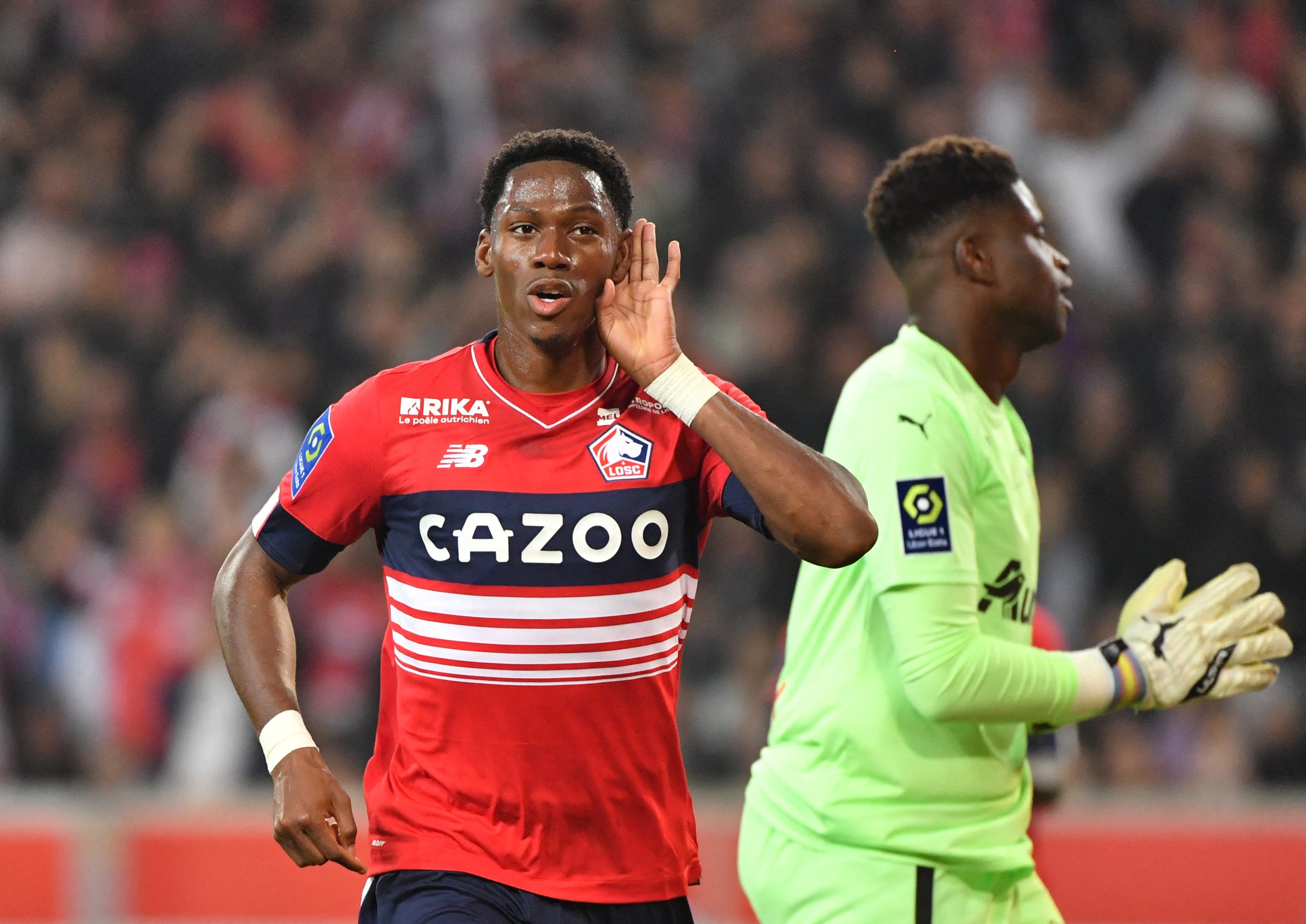 Lille's Canadian forward Jonathan David celebrates after scoring during the French L1 football match between Lille OSC (LOSC) and RC Lens (RCL) at Stade Pierre-Mauroy in Villeneuve-d'Ascq, northern France, on October 9, 2022. (Photo by FRANCOIS LO PRESTI / AFP) (Photo by FRANCOIS LO PRESTI/AFP via Getty Images)