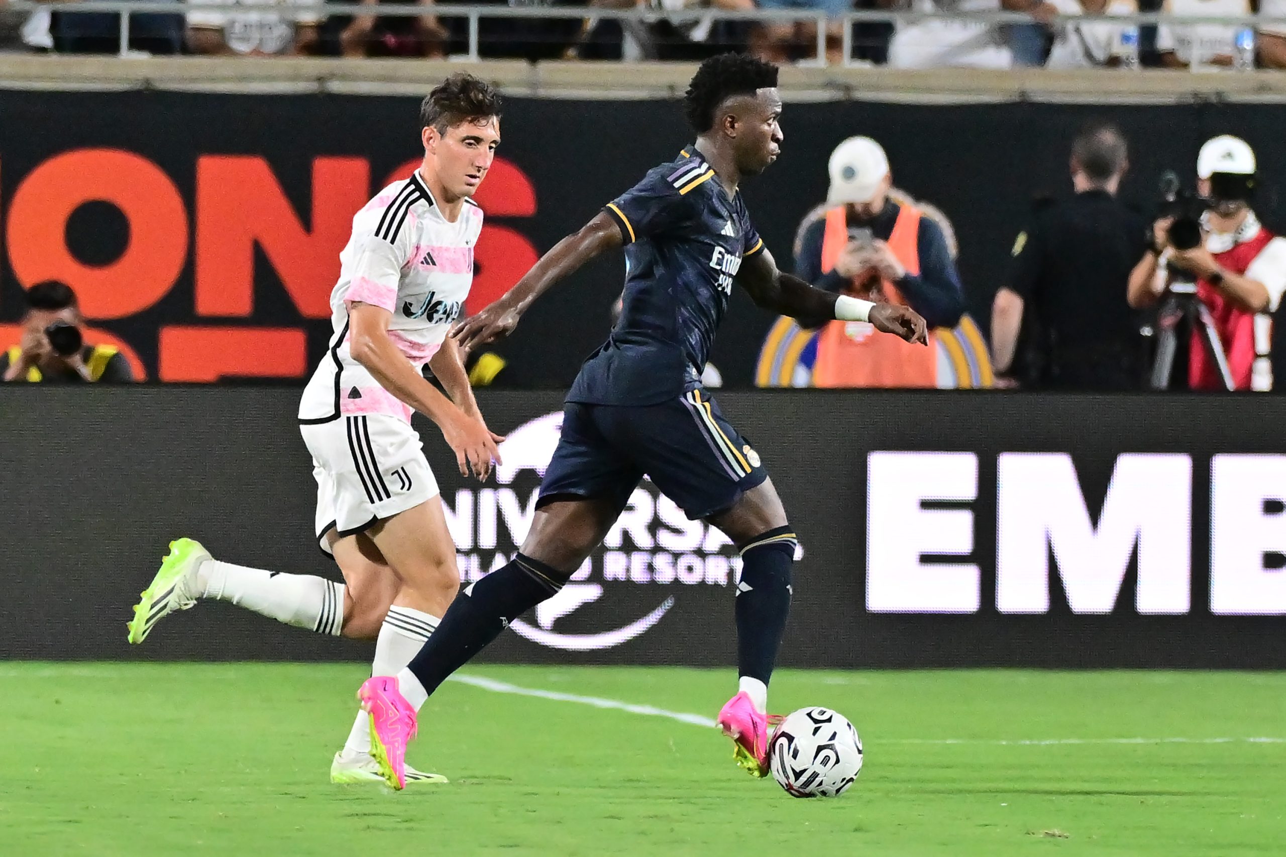 ORLANDO, FLORIDA - AUGUST 02: Vinícius Júnior #7 of Real Madrid looks to pass the ball against Andrea Cambiaso #27 of Juventus during a pre-season friendly match at Camping World Stadium on August 02, 2023 in Orlando, Florida. (Photo by Julio Aguilar/Getty Images)