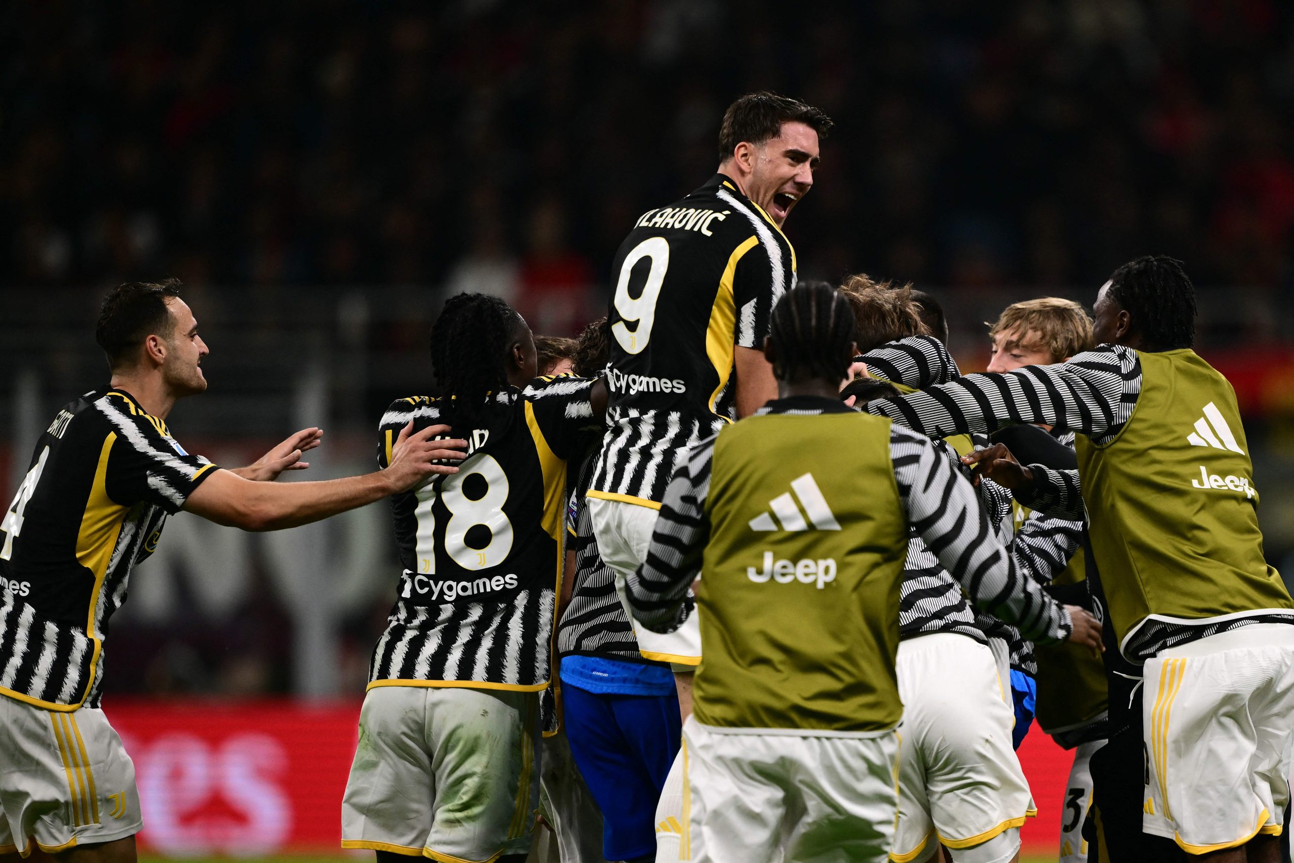 Juventus' Italian midfielder #05 Manuel Locatelli (hidden) celebrates with teammates after scoring the team's first goal during the Italian Serie A football match between Milan and Juventus at San Siro Stadium, in Milan on October 22, 2023. (Photo by Marco BERTORELLO / AFP) (Photo by MARCO BERTORELLO/AFP via Getty Images)