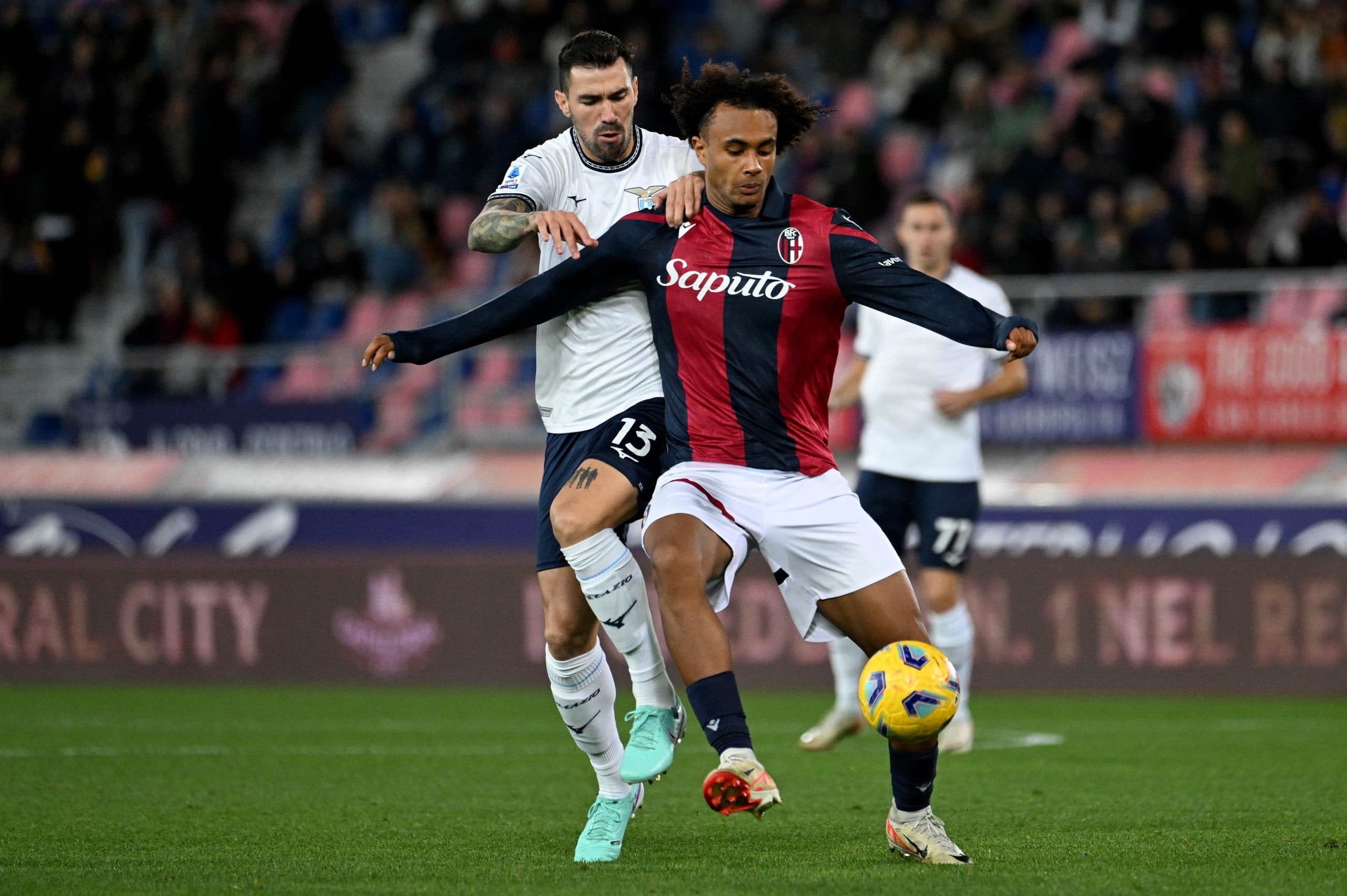 BOLOGNA, ITALY - NOVEMBER 03: Alessio Romagnoli of SS Lazio compete for the ball with Joshua Zirkee during the Serie A TIM match between Bologna FC and SS Lazio at Stadio Renato Dall'Ara on November 03, 2023 in Bologna, Italy. (Photo by Marco Rosi - SS Lazio/Getty Images)