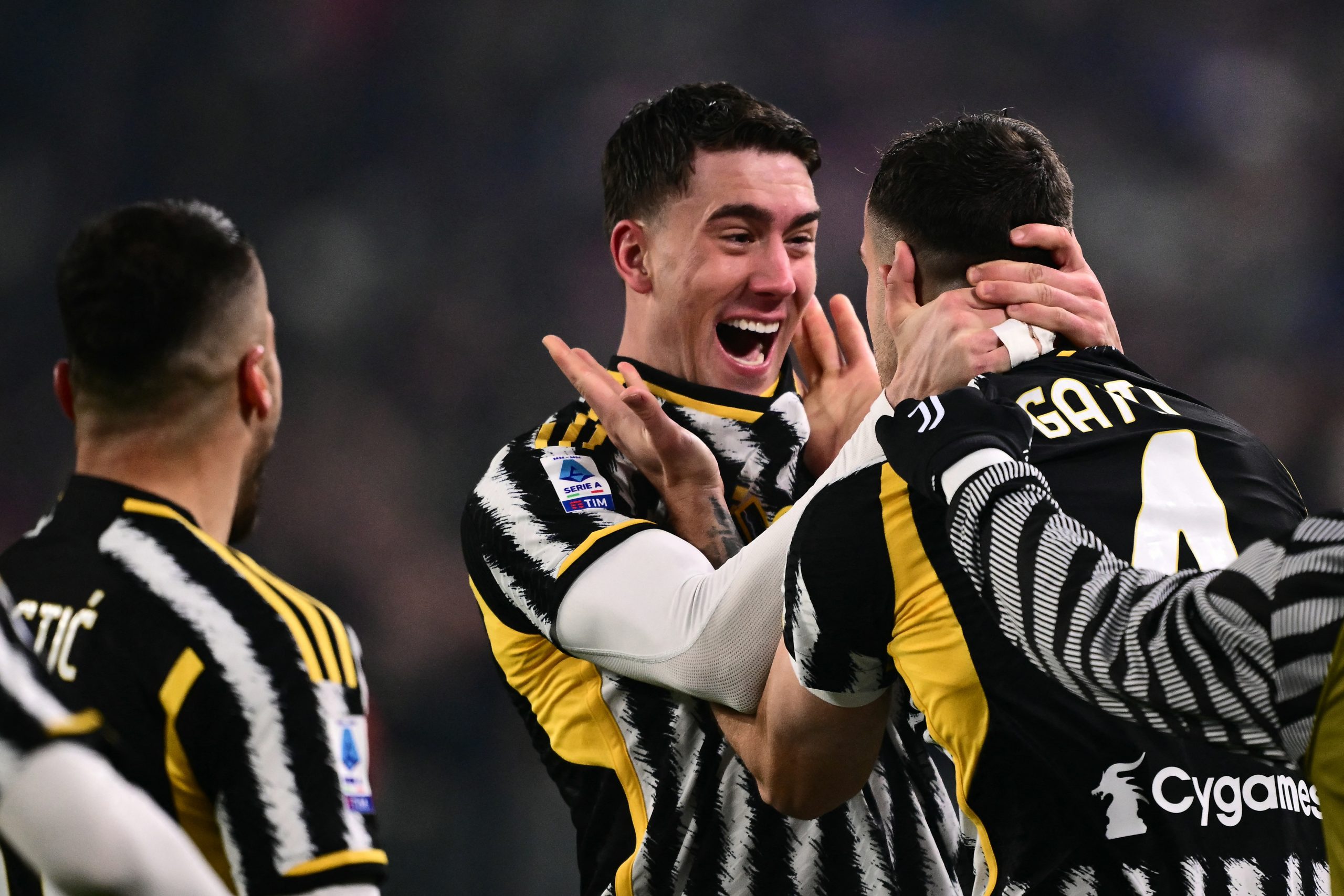 Juventus' Italian defender #04 Federico Gatti celebrates with teammate Juventus' Serbian forward #09 Dusan Vlahovic (C) after scoring the team's first goal during the Italian Serie A football match between Juventus and Napoli, at The Allianz Stadium, in Turin on December 8, 2023. (Photo by Marco BERTORELLO / AFP) (Photo by MARCO BERTORELLO/AFP via Getty Images)