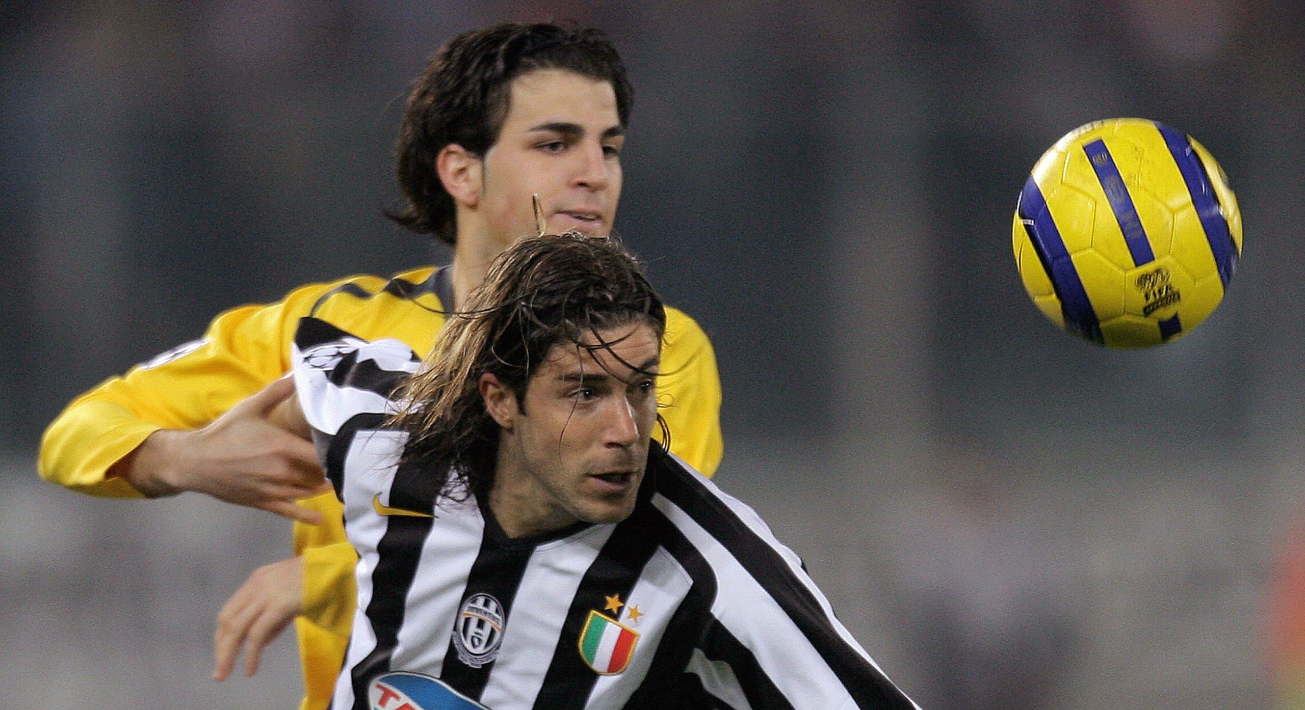 Turin, ITALY: Juventus' midfielder Giuliano Giannichedda (R) fights for the ball with Arsenal's midfielder Francesc Fabregas of Spain during quarter finals second leg Champions league football match 05 April 2006 at Turin's Delle Alpi Stadium. AFP PHOTO / Filippo MONTEFORTE (Photo credit should read FILIPPO MONTEFORTE/AFP via Getty Images)