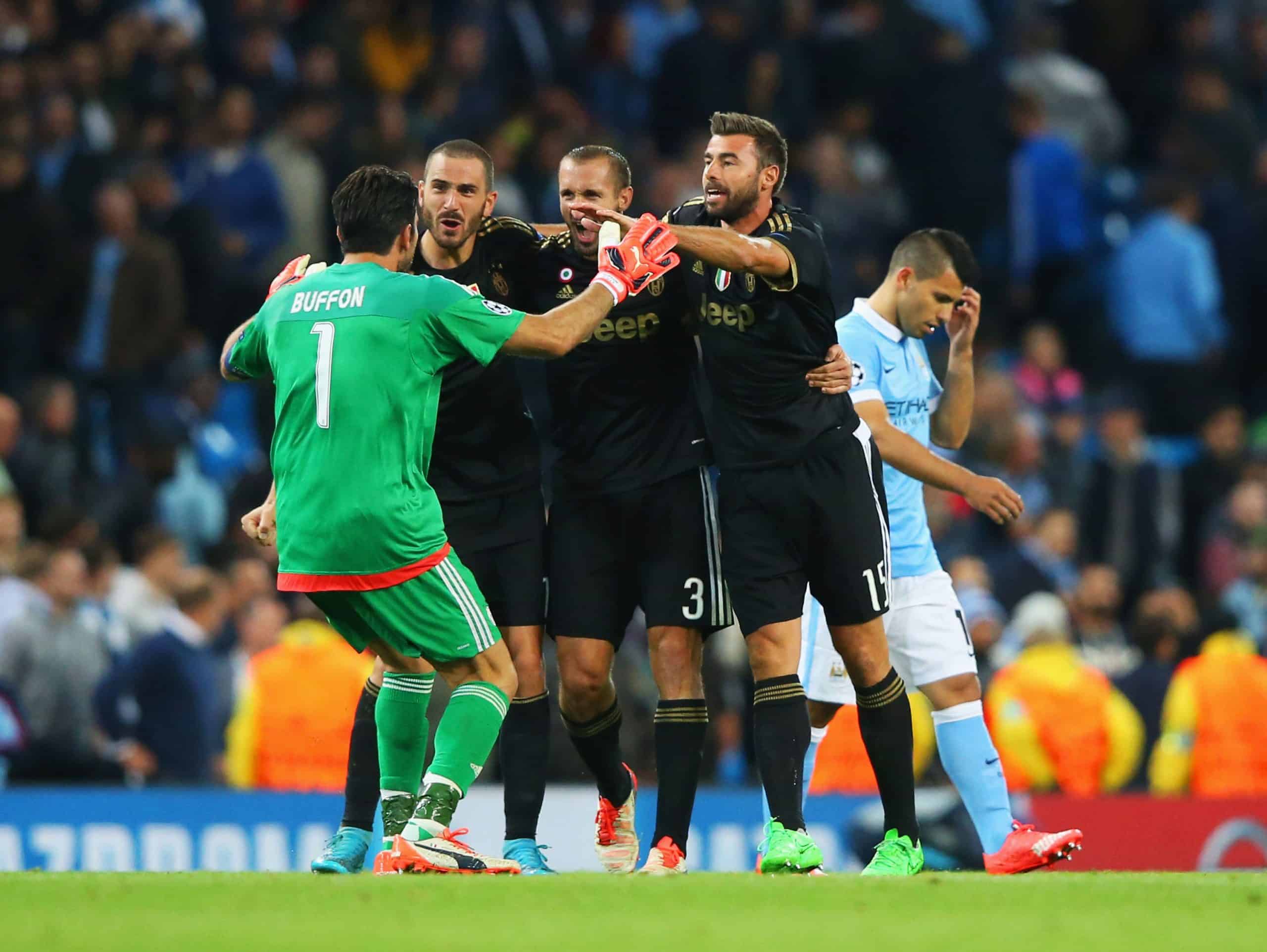MANCHESTER, ENGLAND - SEPTEMBER 15: Gianluigi Buffon, Leonardo Bonucci, Giorgio Chiellini and Andrea Barzagli of Juventus celebrate victory as Sergio Aguero of Manchester City look dejected after the UEFA Champions League Group D match between Manchester City FC and Juventus at the Etihad Stadium on September 15, 2015 in Manchester, United Kingdom. (Photo by Alex Livesey/Getty Images)