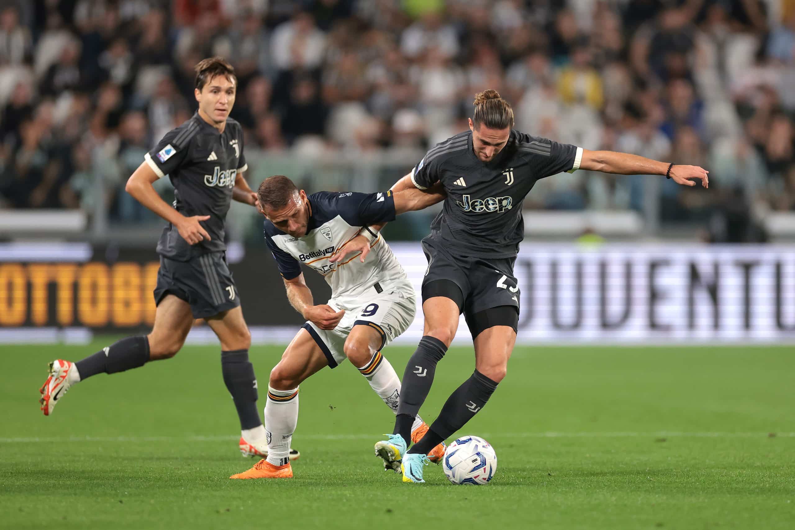 TURIN, ITALY - SEPTEMBER 26: Federico Chiesa of Juventus looks on as Alexis Blin of US Lecce tussles with Adrien Rabiot of Juventus during the Serie A TIM match between Juventus and US Lecce at Allianz Stadium on September 26, 2023 in Turin, Italy. (Photo by Jonathan Moscrop/Getty Images)