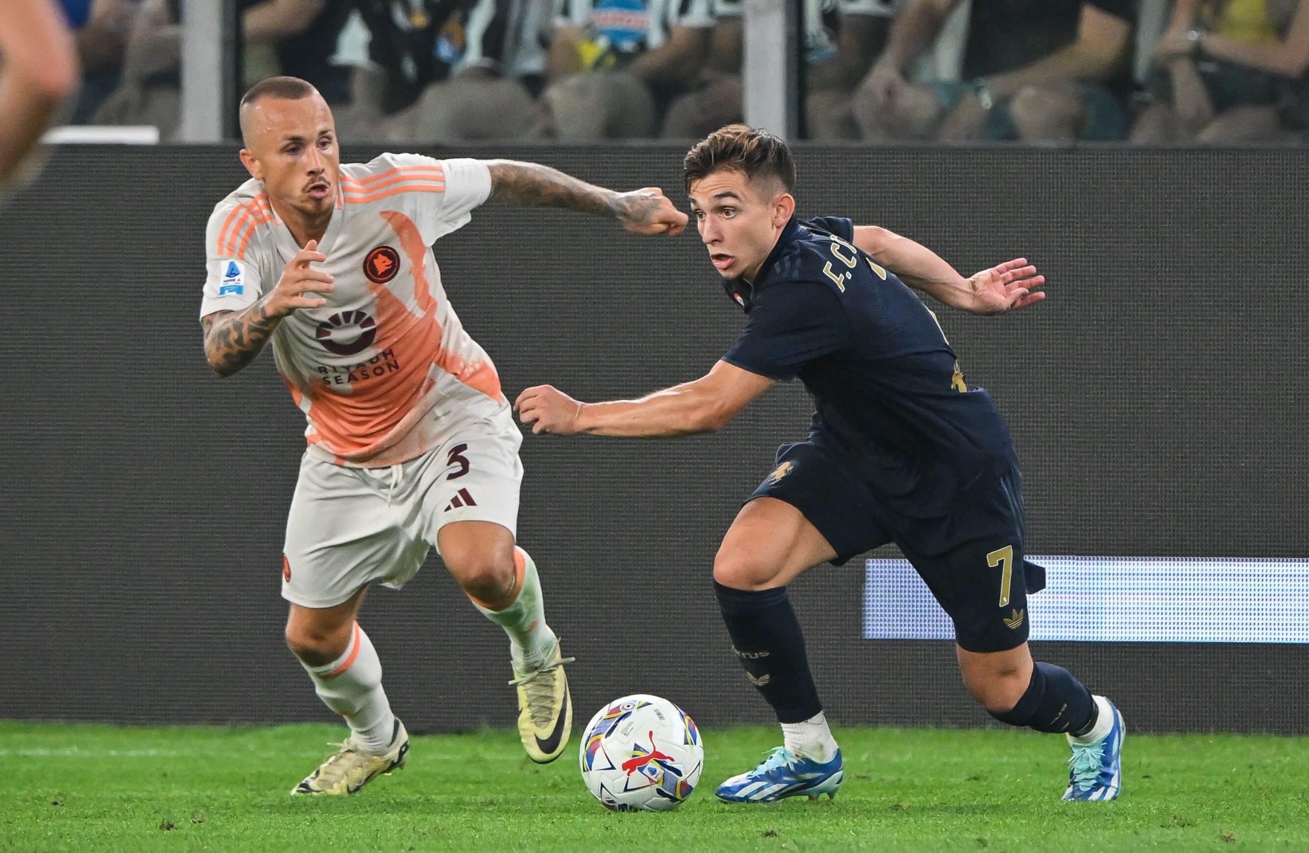 TURIN, ITALY - SEPTEMBER 01: Francisco Conceicao of Juventus evades challenge from Angelino of AS Roma during the Serie A match between Juventus and AS Roma at on September 01, 2024 in Turin, Italy. (Photo by Chris Ricco/Getty Images)
