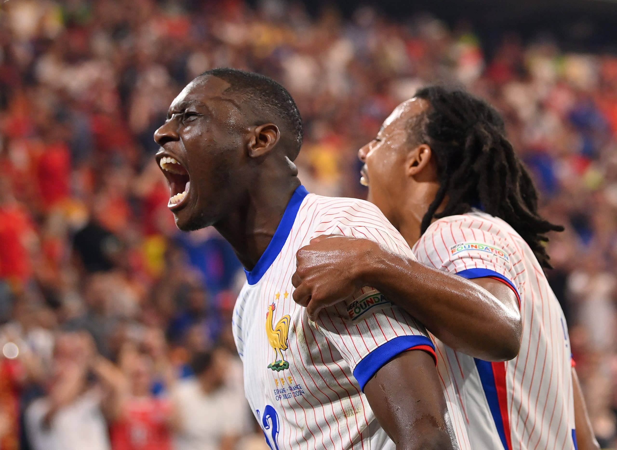 MUNICH, GERMANY - JULY 09: Randal Kolo Muani of France celebrates scoring his team's first goal with teammate Jules Kounde during the UEFA EURO 2024 Semi-Final match between Spain and France at Munich Football Arena on July 09, 2024 in Munich, Germany. (Photo by Stu Forster/Getty Images)
